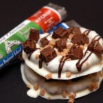 WHITE CHOCOLATE DIPPED PRETZELS TOPPED WITH WORLD’S FINEST CHOCOLATE BARS!