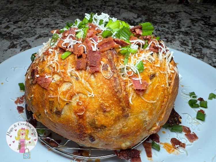 sourdough jalapeno popper loaf with cheese and bacon and scallions on top